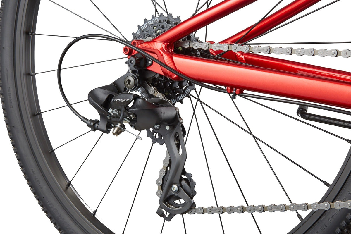 Close-up of Shimano Tourney rear derailleur and cassette on Cannondale Kids Quick C2 metallic red bike