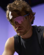 Man wearing KOO Nebula sunglasses in Iris Matt frame with Super Pink Mirror lenses