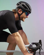 Cyclist wearing Kask Protone helmet in matte black with aerodynamic cycling position