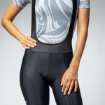 Woman wearing black ALE PRR Strada cycling bibshorts with gray patterned jersey