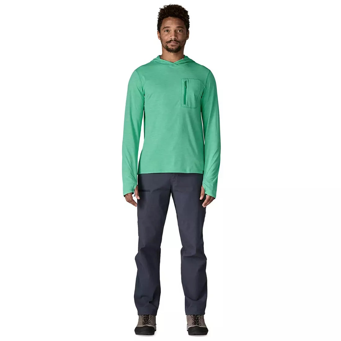 Man wearing green hooded long-sleeve shirt with chest pocket and dark pants