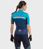 Woman wearing ALE cycling jersey with turquoise, navy, and rainbow stripe design