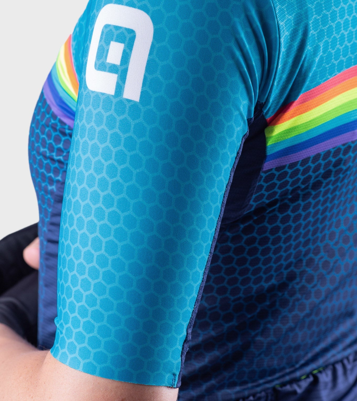 ALE women's cycling jersey in turquoise blue with rainbow accents and hexagonal pattern