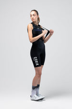 Woman wearing black GOBIK Lancer cycling bib shorts in professional studio photo