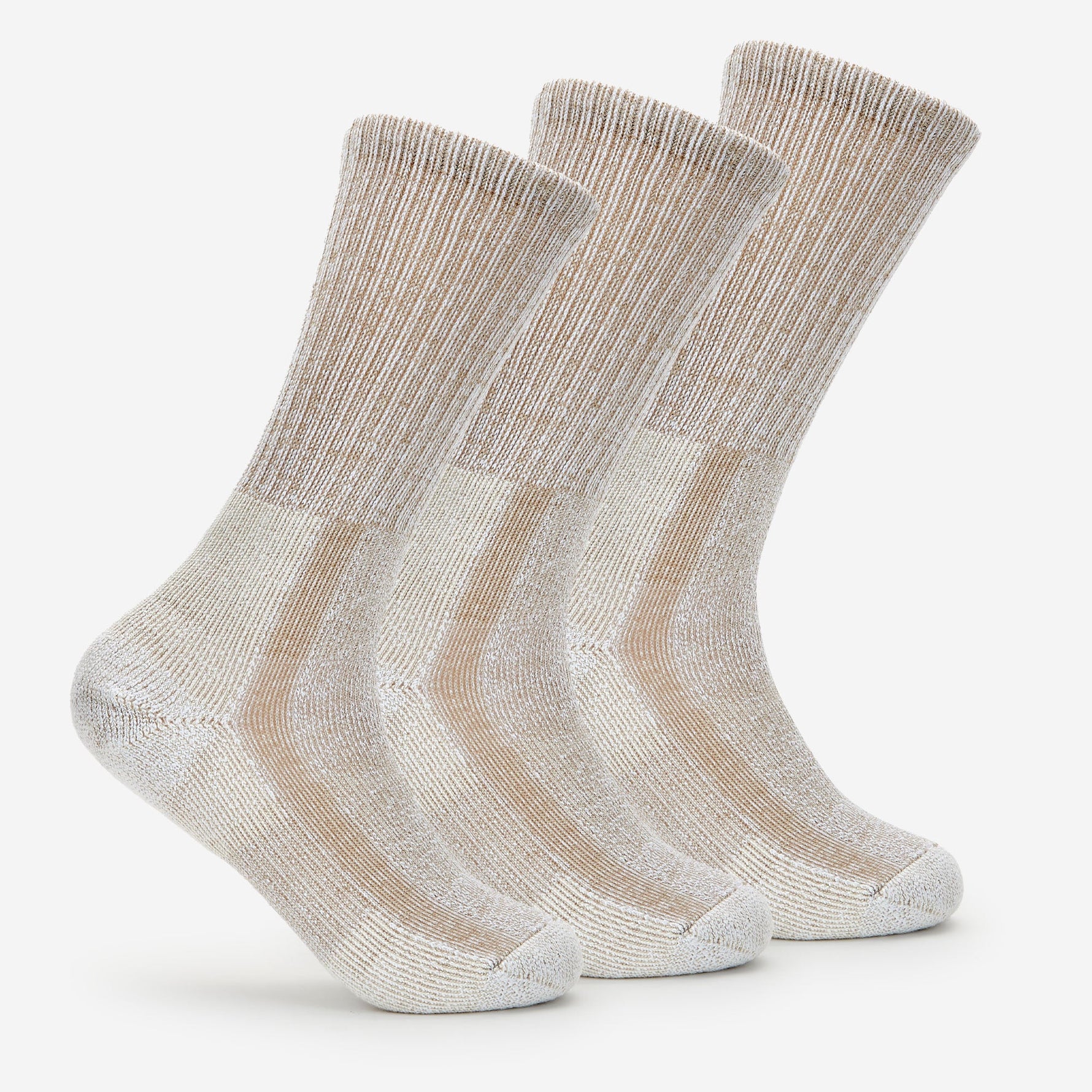 Three pairs of light brown Thorlos crew running socks with cushioned design