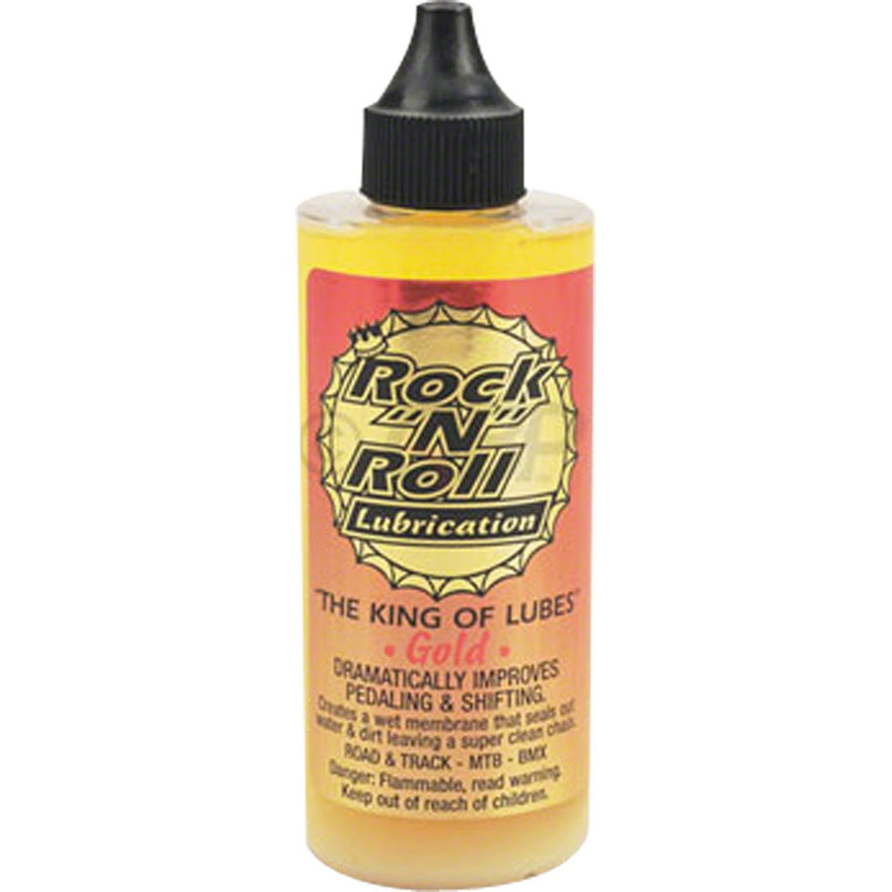 Rock N Roll Gold bicycle chain lubricant bottle with yellow liquid and red label