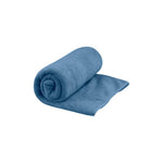 Sea To Summit Tek Towel in blue color, partially rolled up