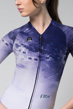 Woman wearing Gobik CX Pro cycling jersey with blue gradient digital pattern