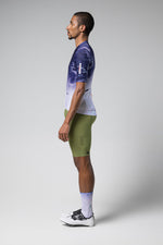 Male model wearing Gobik CX Pro jersey in blue gradient pattern with green cycling shorts