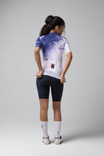 Woman wearing Gobik CX Pro cycling jersey in purple gradient, rear view