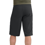 Black athletic shorts on model with olive green shirt, studio photography
