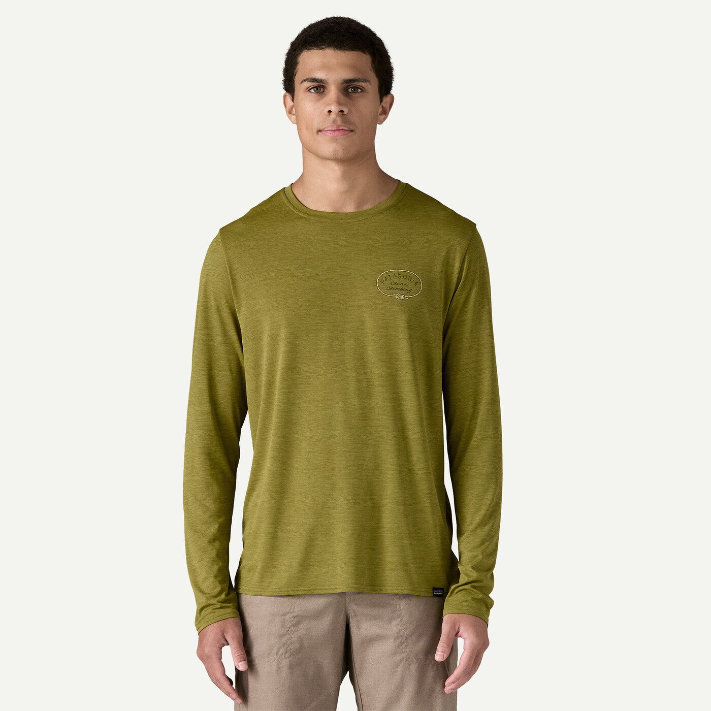 Man wearing olive green Patagonia long-sleeve shirt with small chest logo