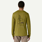 Back view of man wearing olive green Patagonia long-sleeved shirt with tree graphic