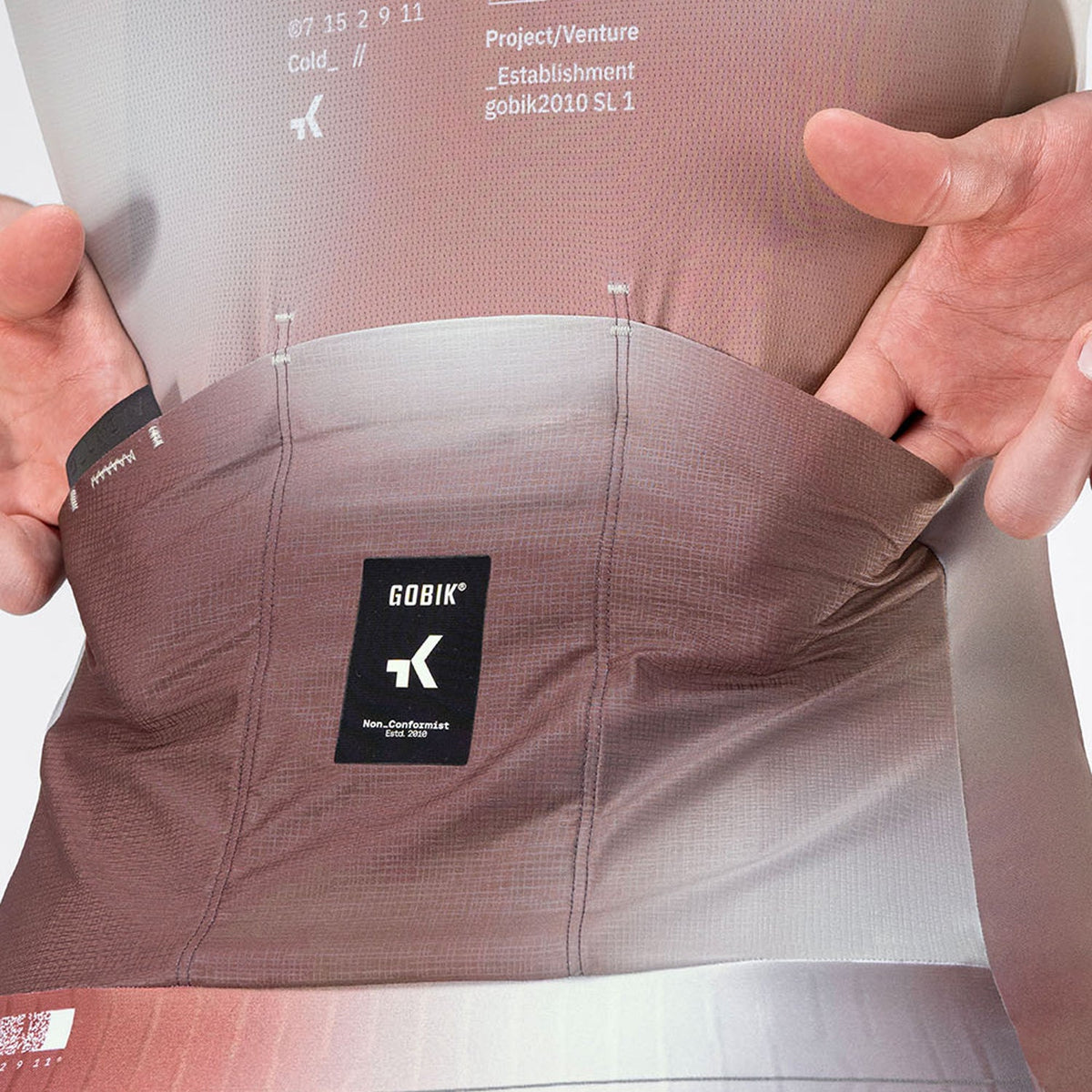 Close-up of Gobik Attitude 2.0 jersey back pockets being stretched open to show capacity
