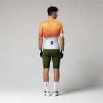 Gobik Attitude2.0 men's cycling jersey in muskmelon orange gradient, back view on model