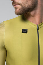 Man wearing olive green Gobik cycling jersey with zipper and brand logo