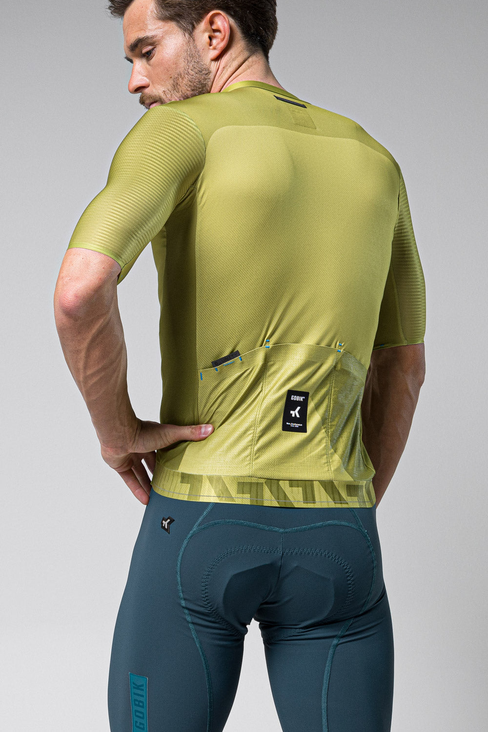 Gobik Magnitude short sleeve cycling jersey in split green colorway, rear view