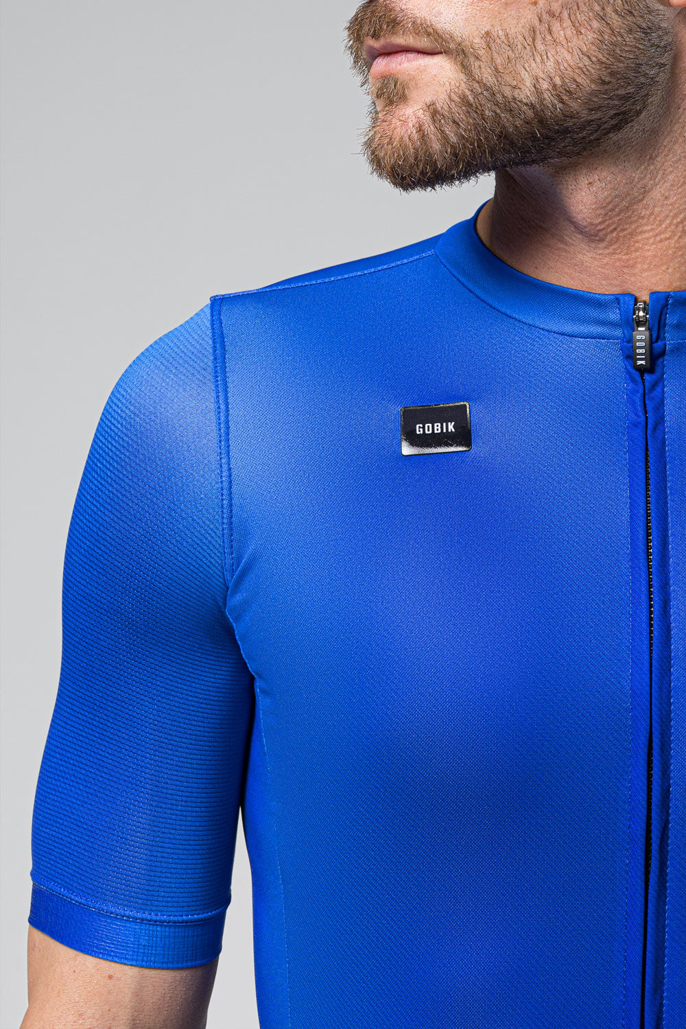 Man wearing bright blue Gobik cycling jersey with zipper and logo
