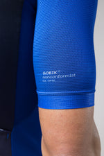 Close-up of GOBIK cycling jersey sleeve hem showing blue fabric texture and branding