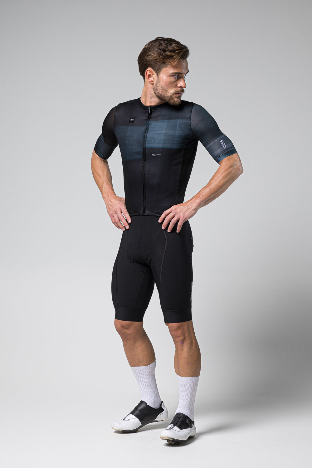 Male cyclist wearing black Gobik Stark short sleeve jersey with navy gradient panel