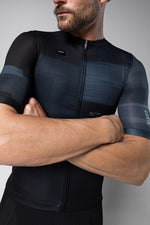Man wearing Gobik Stark cycling jersey in dark blue moonless colorway with arms crossed