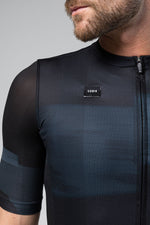 Man wearing Gobik Stark short sleeve cycling jersey in moonless dark navy colorway