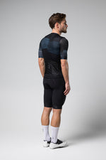Gobik Stark cycling jersey in Moonless colorway shown on male model from behind