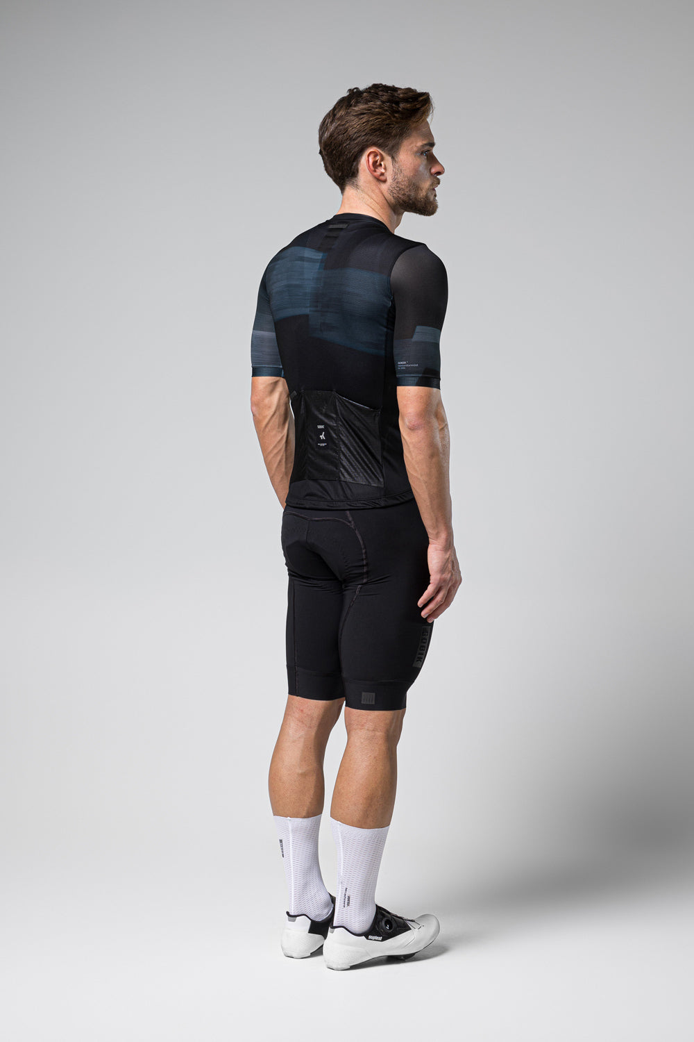 Gobik Stark cycling jersey in Moonless colorway shown on male model from behind