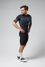 Male cyclist wearing Gobik Stark short sleeve jersey in black and blue pattern