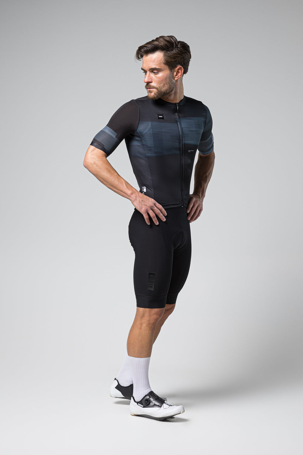 Male cyclist wearing Gobik Stark short sleeve jersey in black and blue pattern