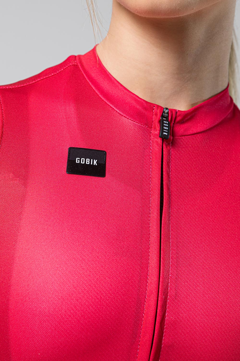 Gobik Stark women's cycling jersey in azalea pink with black logo and zipper detail