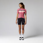 Woman wearing Gobik Stark pink cycling jersey with black shorts and white socks
