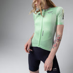 Woman wearing mint green Gobik cycling jersey with full zip front