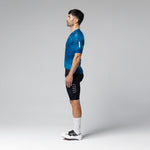 Man wearing Gobik CX 2.0 Pro blue cycling jersey and black shorts in studio