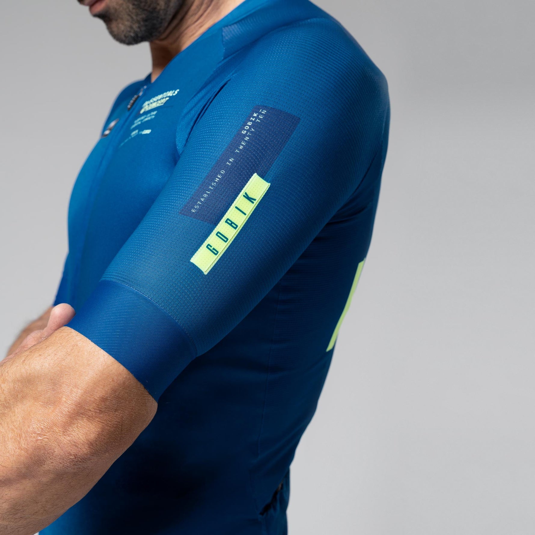 Man wearing blue Gobik CX 2.0 Pro cycling jersey with yellow accents