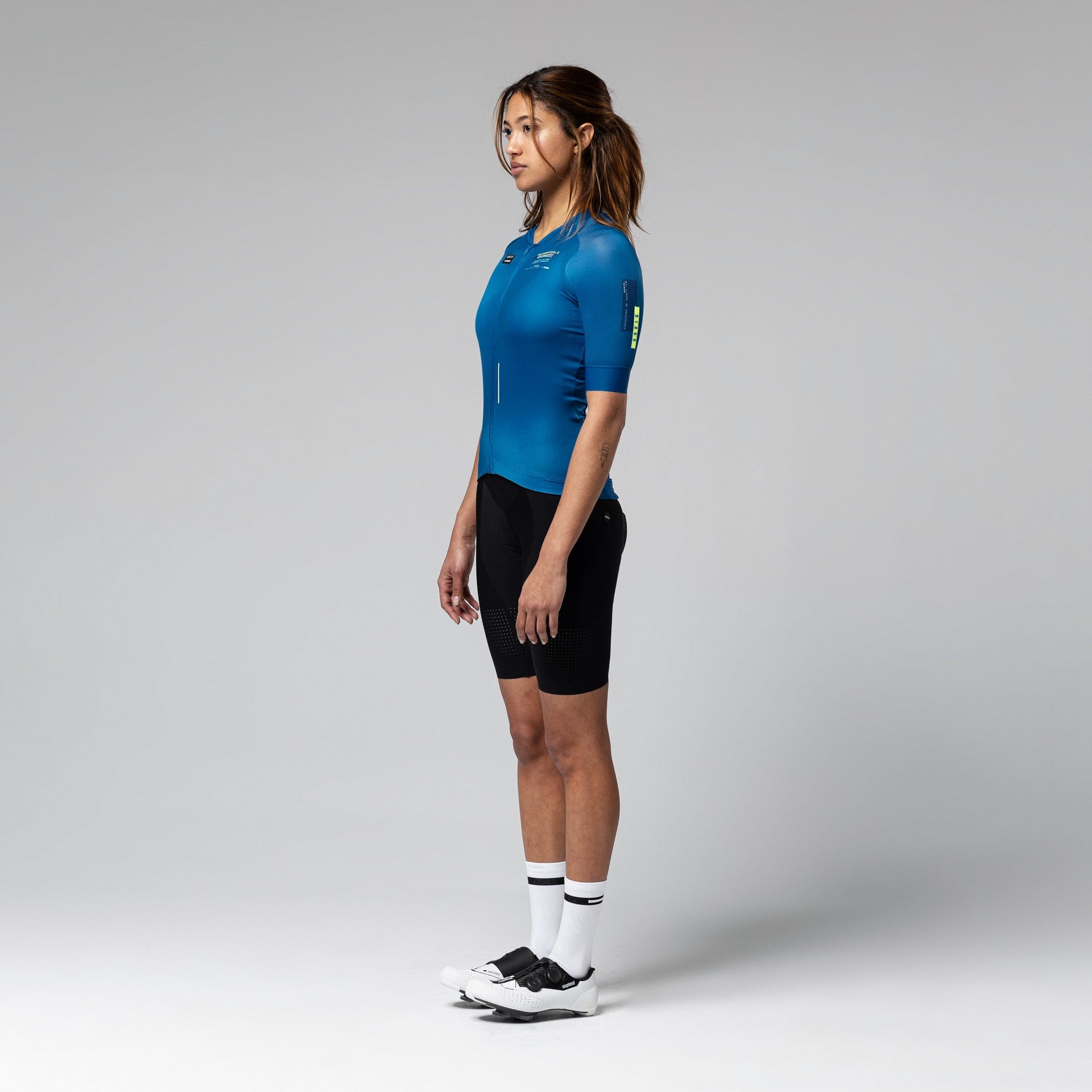 Woman wearing blue Gobik CX 2.0 Pro cycling jersey with black shorts