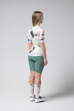 Woman wearing Gobik CX Pro cycling jersey with tie-dye pattern and green shorts