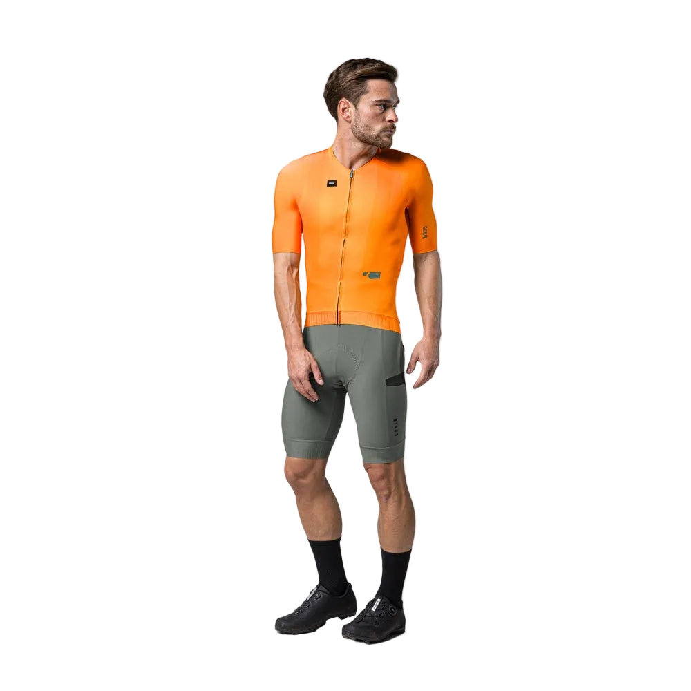Man wearing bright orange Gobik CX Pro cycling jersey with olive green shorts
