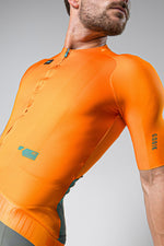 Male cyclist wearing bright orange Gobik CX Pro cycling jersey with short sleeves