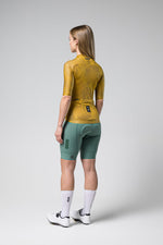 Gobik Infinity cycling jersey in ginger yellow with matching shorts, back view