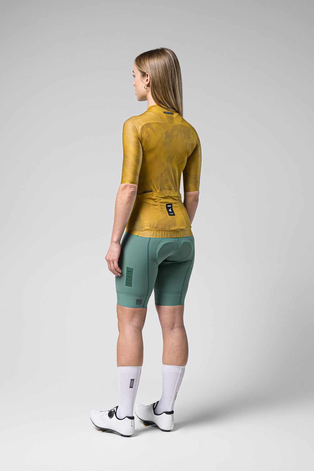 Gobik Infinity cycling jersey in ginger yellow with matching shorts, back view