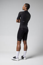 Man wearing black Gobik Phantom cycling jersey and shorts in studio photo