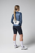 Back view of woman wearing Gobik CX Pro 2.0 long sleeve cycling jersey in blue