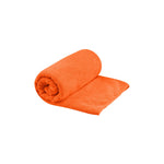 Sea To Summit Tek Towel in bright orange color, partially rolled up