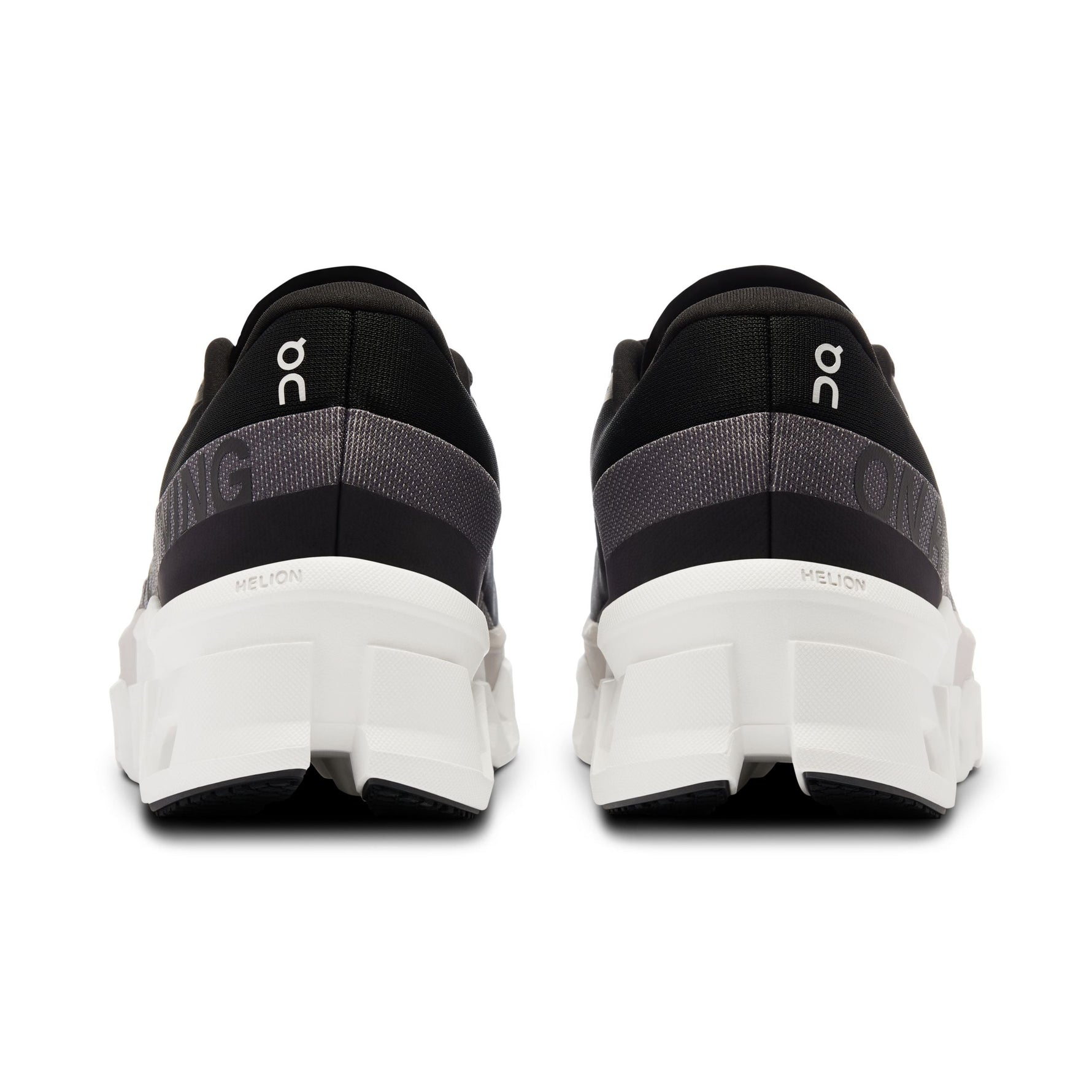 On Cloudmonster 2 running shoes in black and frost colorway, rear view