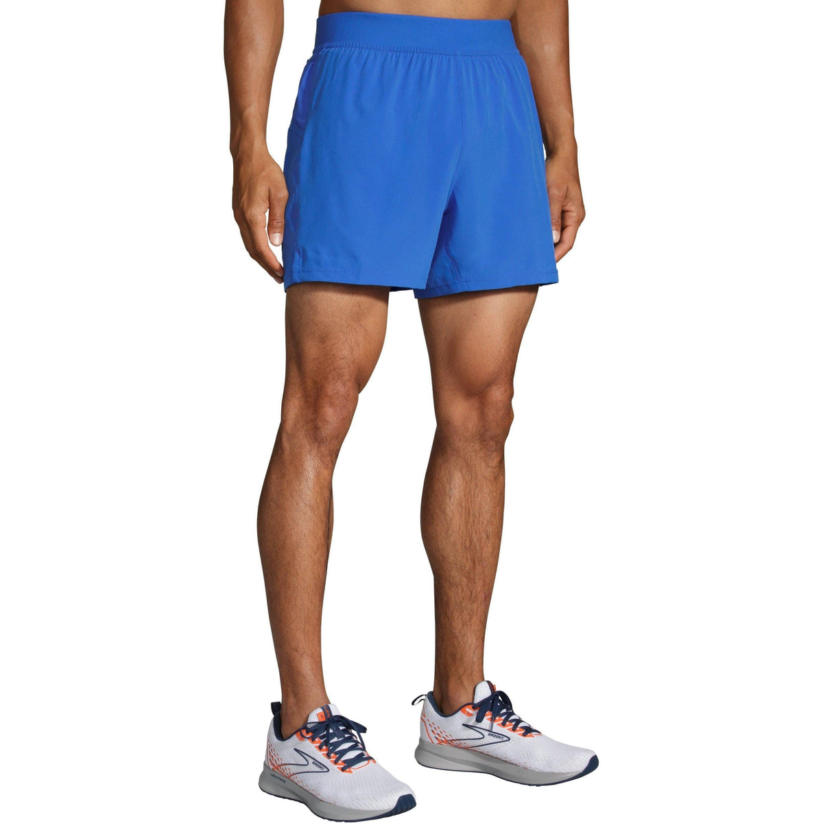 Brooks Sherpa 5-inch running shorts in Amparo Blue worn by male model with white Brooks sneakers