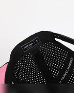 Close-up interior detail of Wrld Tags Miami hat showing brand label, pink lining and perforated fabric