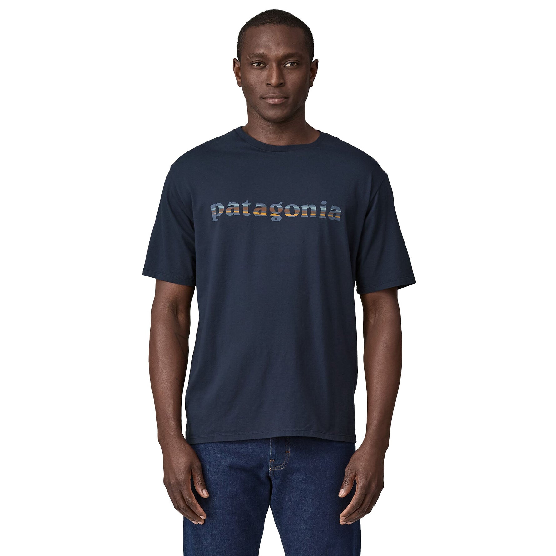 Man wearing Patagonia navy blue t-shirt with colorful text logo on chest