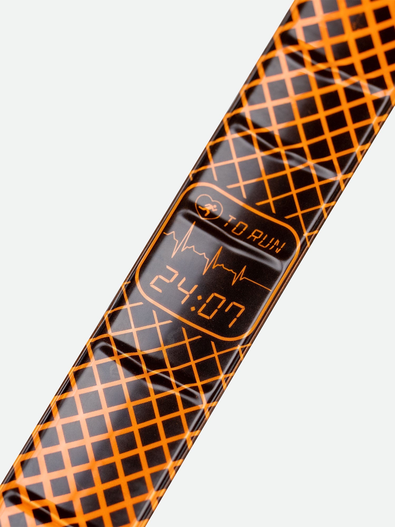 Nathan Reflex orange reflective slap band with digital display showing 24:07 and grid pattern