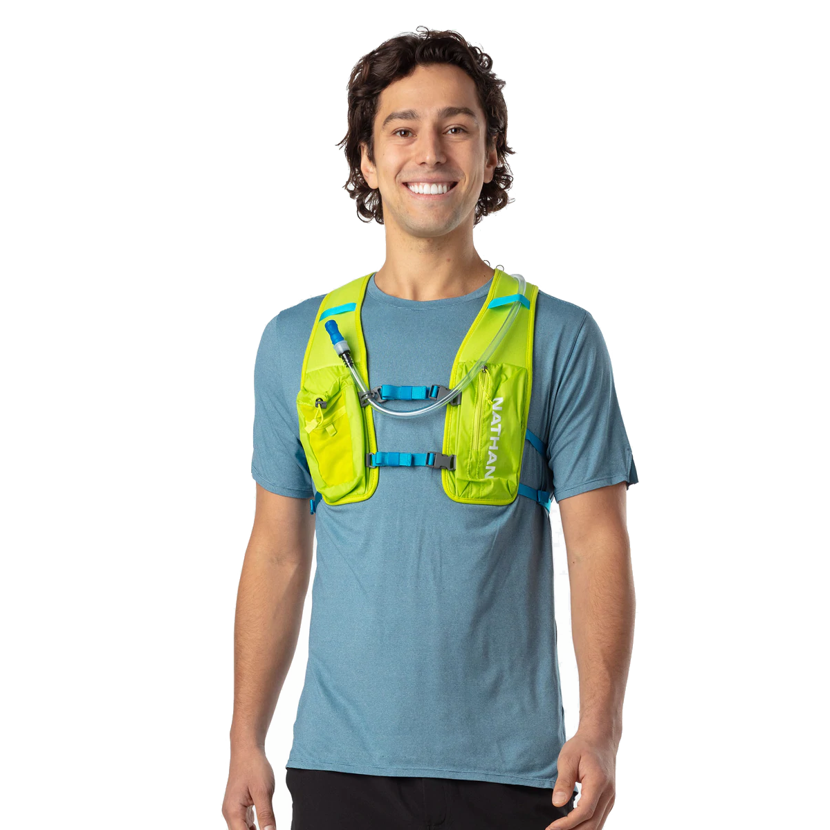 Man wearing Nathan QuickStart 2.0 hydration vest in lime green with blue straps